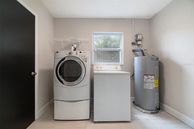 laundry room with light tile patterned floors, baseboards, washer and dryer, electric water heater, and laundry area