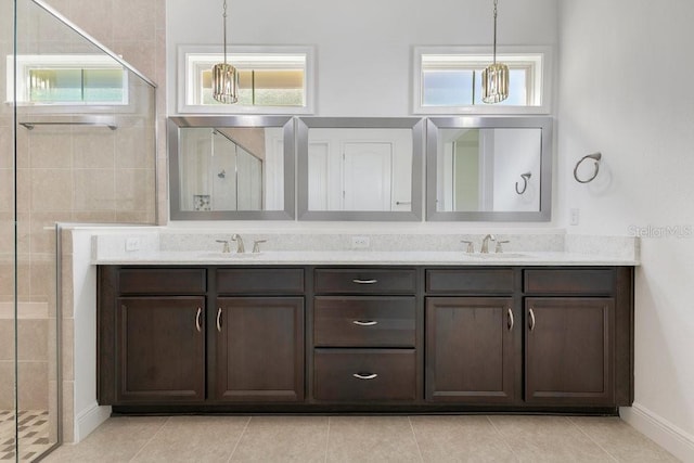 bathroom featuring double vanity, a shower stall, and a sink