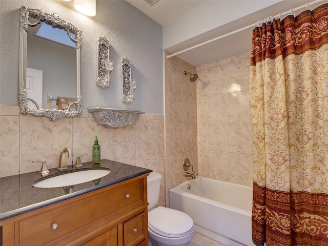 full bath with tile walls, vanity, shower / bath combo with shower curtain, toilet, and visible vents