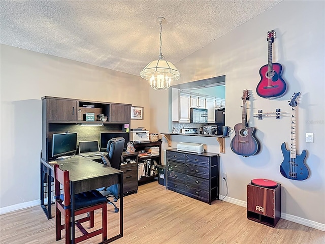 1021 Whalebone Bay Dr, Kissimmee, FL 34741 - office area featuring baseboards, light wood-type flooring, a notable chandelier, and a textured ceiling