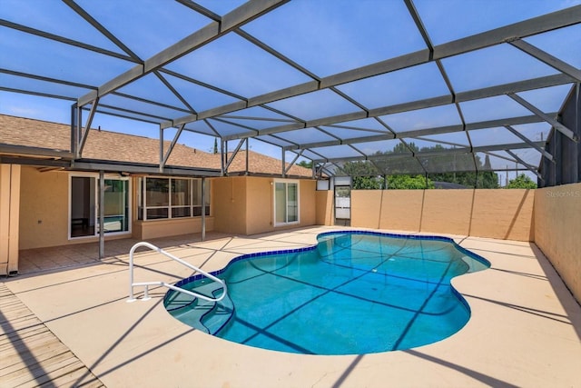 outdoor pool with a ceiling fan and a patio area