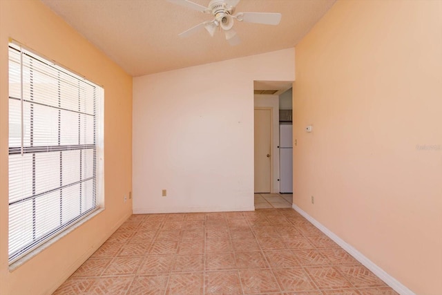unfurnished room featuring baseboards, ceiling fan, and lofted ceiling