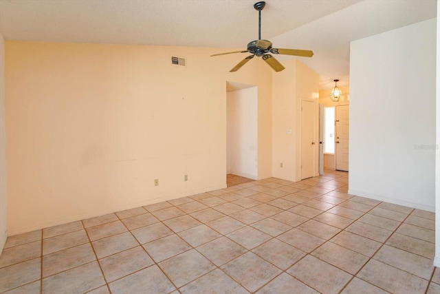 spare room with visible vents, ceiling fan, light tile patterned flooring, and lofted ceiling