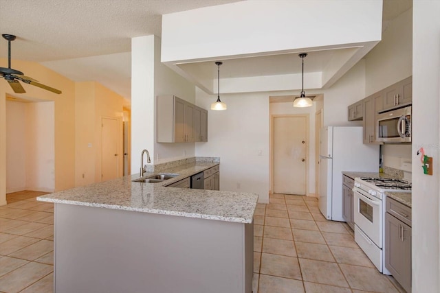 kitchen with a sink, light tile patterned floors, a ceiling fan, gray cabinetry, and appliances with stainless steel finishes