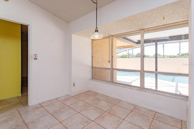 unfurnished dining area featuring light tile patterned flooring