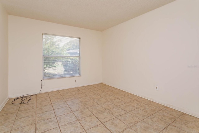 unfurnished room featuring light tile patterned flooring