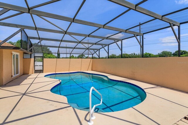outdoor pool with a patio and a lanai