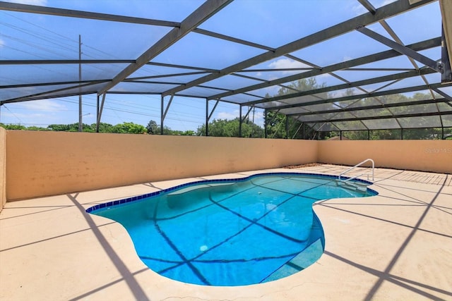 view of pool with a patio, glass enclosure, and a fenced in pool