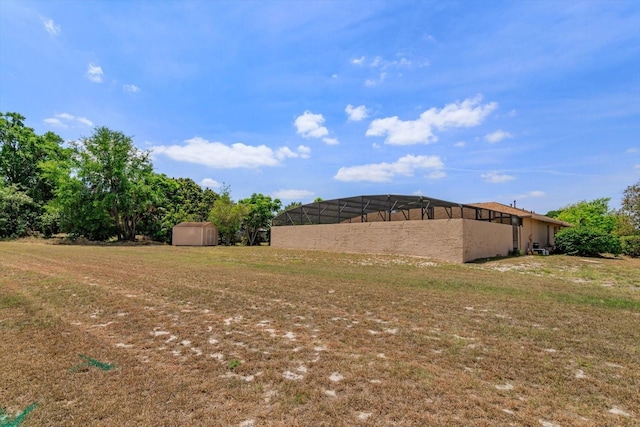 view of yard featuring an outbuilding and a storage shed
