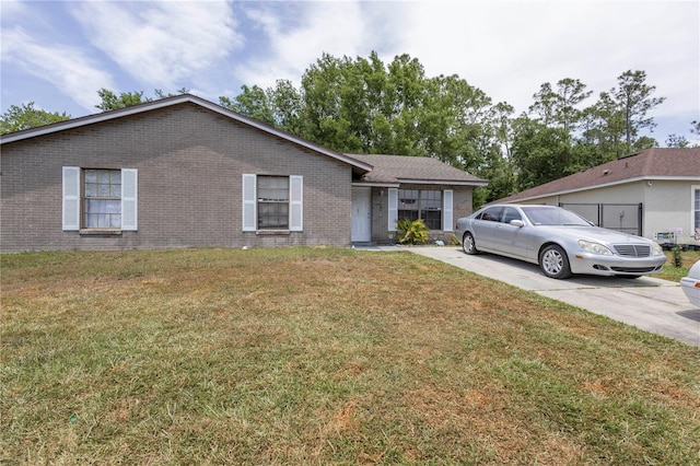 349 Caldbeck Way, Kissimmee, FL 34758 - ranch-style house featuring a front lawn and brick siding