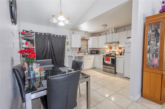 349 Caldbeck Way, Kissimmee, FL 34758 - dining area with lofted ceiling, light tile patterned flooring, and a chandelier