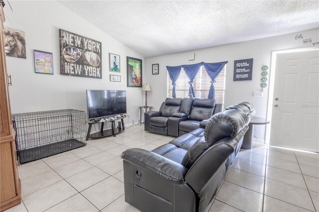 349 Caldbeck Way, Kissimmee, FL 34758 - living area with a textured ceiling, light tile patterned flooring, and vaulted ceiling
