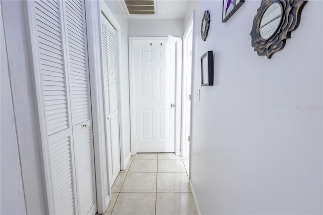 349 Caldbeck Way, Kissimmee, FL 34758 - corridor with visible vents, baseboards, and light tile patterned floors