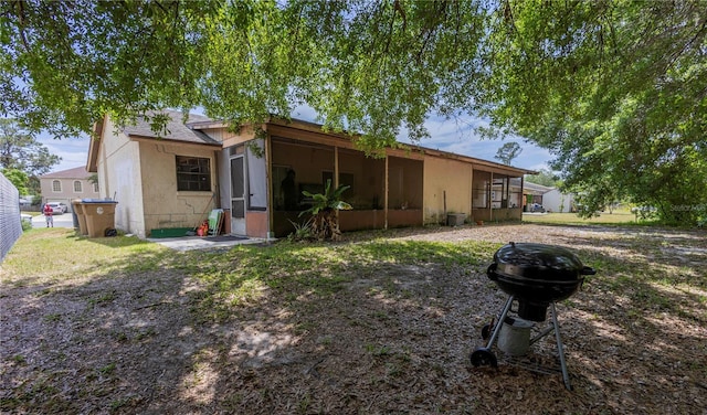 349 Caldbeck Way, Kissimmee, FL 34758 - back of property featuring a sunroom and stucco siding