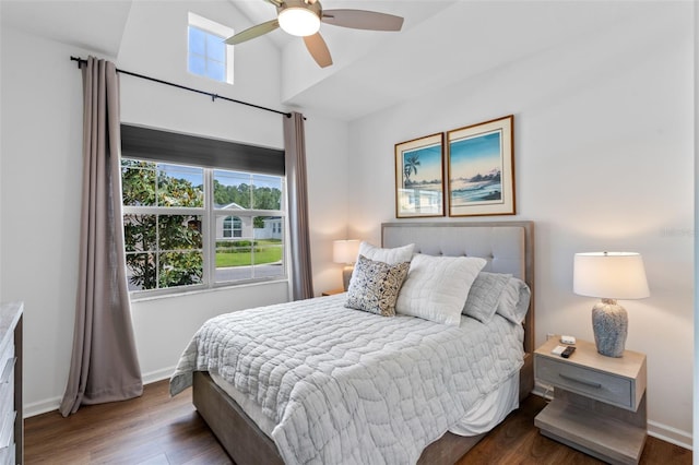 bedroom featuring baseboards, a ceiling fan, and wood finished floors