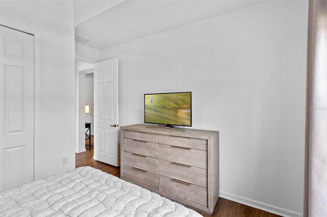 bedroom with baseboards and dark wood-style floors