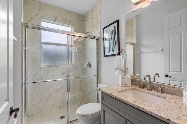 full bathroom featuring vanity, toilet, and a stall shower