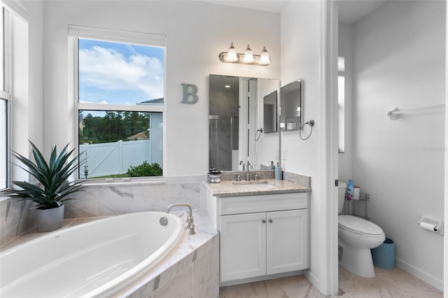 full bath featuring vanity, toilet, baseboards, a shower, and a garden tub