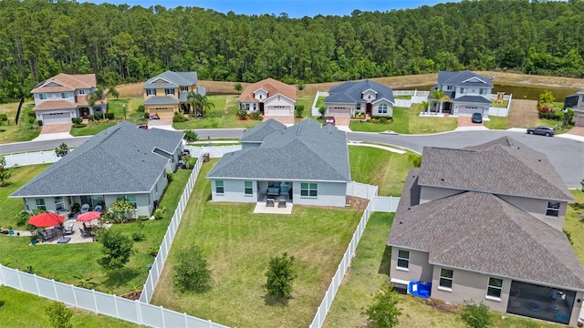 birds eye view of property with a residential view and a forest view