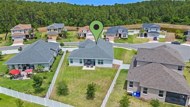 birds eye view of property featuring a forest view and a residential view