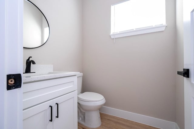 2041 Warrens Ave, Maitland, FL 32751 - half bathroom featuring vanity, baseboards, toilet, and wood finished floors