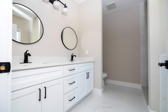 2041 Warrens Ave, Maitland, FL 32751 - full bath with double vanity, visible vents, a sink, toilet, and marble finish floor