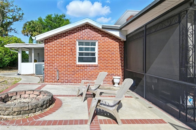 view of patio / terrace with an outdoor fire pit and central air condition unit