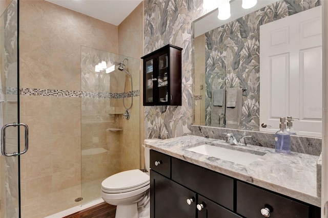 1767 Piedmont Pl, Lake Mary, FL 32746 - full bathroom featuring vanity, toilet, tile walls, a shower stall, and wood finished floors
