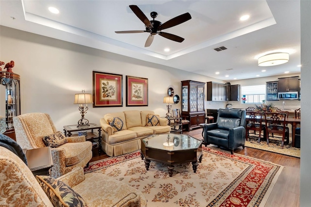 1767 Piedmont Pl, Lake Mary, FL 32746 - living room featuring a raised ceiling, a ceiling fan, recessed lighting, wood finished floors, and visible vents