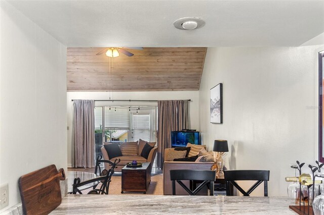 interior space featuring ceiling fan and vaulted ceiling