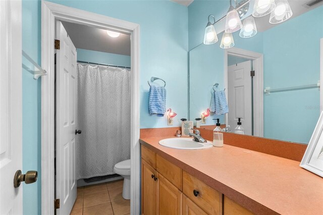 full bathroom with vanity, tile patterned flooring, toilet, and visible vents