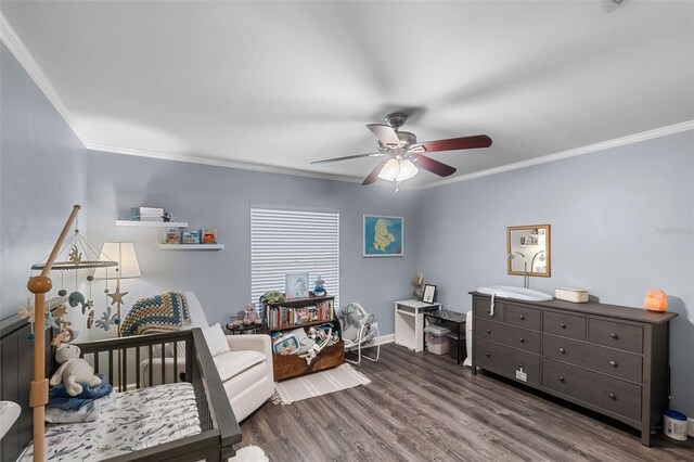bedroom featuring crown molding, a ceiling fan, baseboards, and wood finished floors