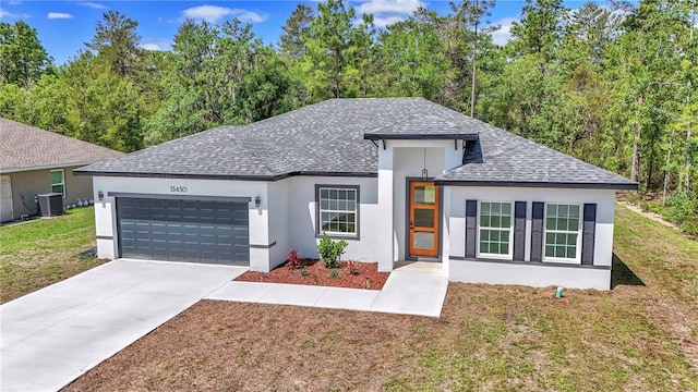 13430 SW 88th Ter, Ocala, FL 34473 - ranch-style home with roof with shingles, central AC, a garage, stucco siding, and a front yard