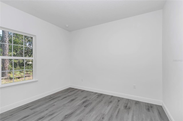 13430 SW 88th Ter, Ocala, FL 34473 - spare room with baseboards and wood finished floors