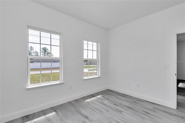 13430 SW 88th Ter, Ocala, FL 34473 - unfurnished room featuring baseboards, a wealth of natural light, and light wood-style flooring