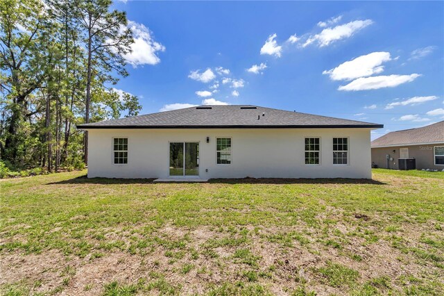 13430 SW 88th Ter, Ocala, FL 34473 - back of property featuring a yard, central AC unit, and stucco siding