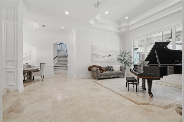 5550 Osprey Isle Ln, Orlando, FL 32819 - living area with crown molding, arched walkways, stairs, recessed lighting, and a tray ceiling