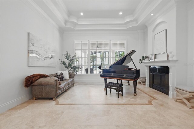 5550 Osprey Isle Ln, Orlando, FL 32819 - living area featuring baseboards, a glass covered fireplace, ornamental molding, a tray ceiling, and recessed lighting