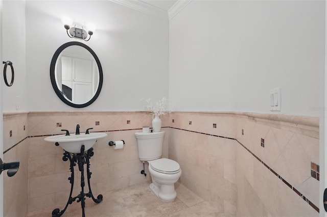 5550 Osprey Isle Ln, Orlando, FL 32819 - half bath featuring tile patterned flooring, ornamental molding, toilet, tile walls, and a wainscoted wall