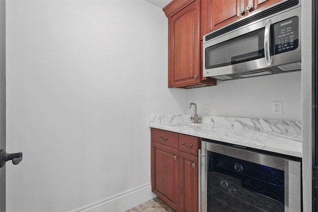 5550 Osprey Isle Ln, Orlando, FL 32819 - bar with indoor wet bar, stainless steel microwave, baseboards, and wine cooler