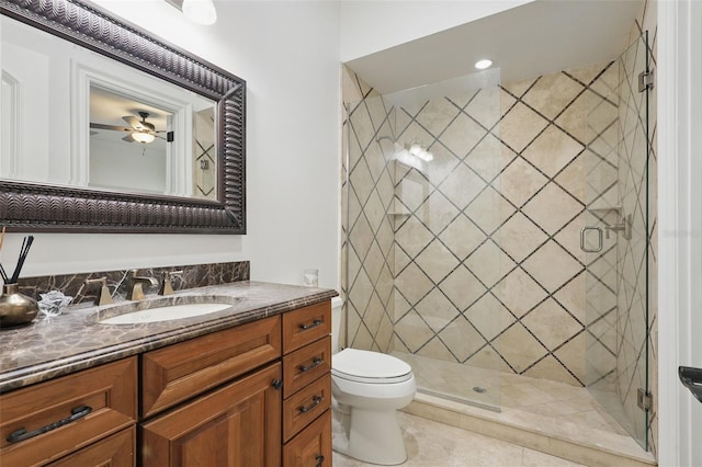 5550 Osprey Isle Ln, Orlando, FL 32819 - full bathroom featuring vanity, tile patterned flooring, toilet, ceiling fan, and a shower stall