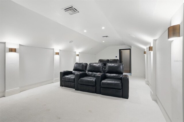 5550 Osprey Isle Ln, Orlando, FL 32819 - home theater with light colored carpet, baseboards, visible vents, and lofted ceiling