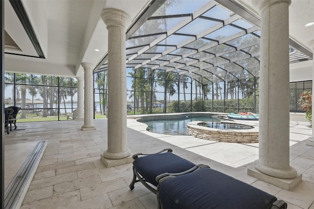 5550 Osprey Isle Ln, Orlando, FL 32819 - view of pool featuring glass enclosure, a patio, and a pool with connected hot tub
