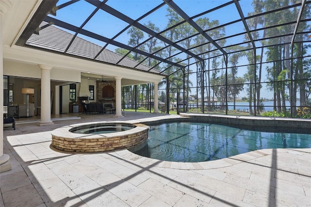 5550 Osprey Isle Ln, Orlando, FL 32819 - view of swimming pool featuring a patio, a pool with connected hot tub, and a water view