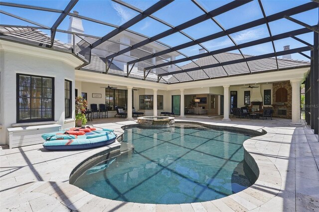 5550 Osprey Isle Ln, Orlando, FL 32819 - view of pool featuring glass enclosure, a patio, ceiling fan, and a pool with connected hot tub