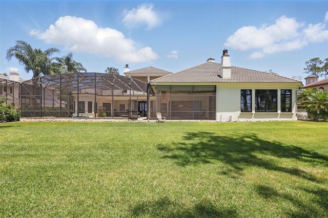 5550 Osprey Isle Ln, Orlando, FL 32819 - back of property with stucco siding, a yard, and a chimney