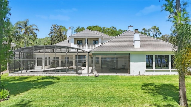 5550 Osprey Isle Ln, Orlando, FL 32819 - back of property with stucco siding, a chimney, a patio area, a lawn, and a lanai
