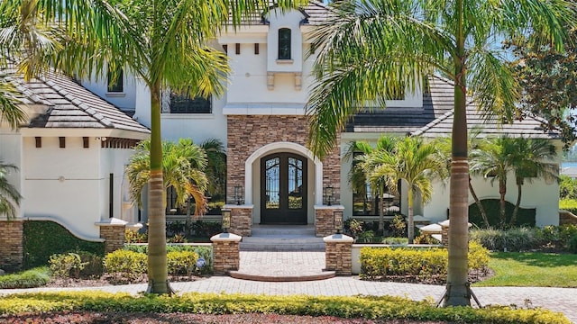 5550 Osprey Isle Ln, Orlando, FL 32819 - entrance to property featuring french doors and stucco siding