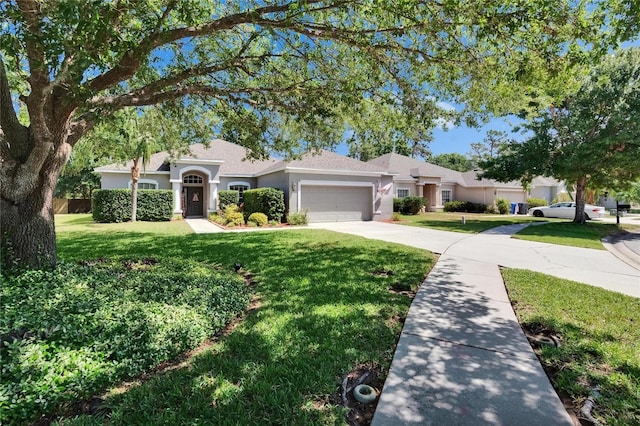 ranch-style home featuring an attached garage, stucco siding, driveway, and a front lawn