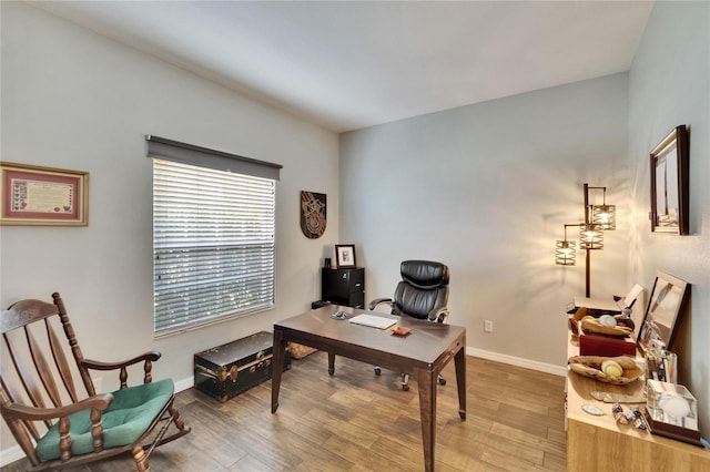 office area with baseboards and wood finished floors